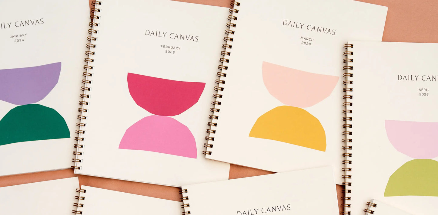 Four 'Daily Canvas' planners with colorful geometric designs on a white background